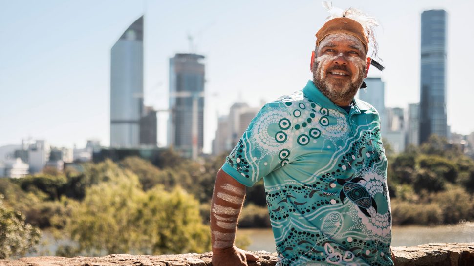 Traditional Owner, Uncle Shannon Ruska wears a traditional head dress while looking out over the Brisbane River in Meanjin / Brisbane.